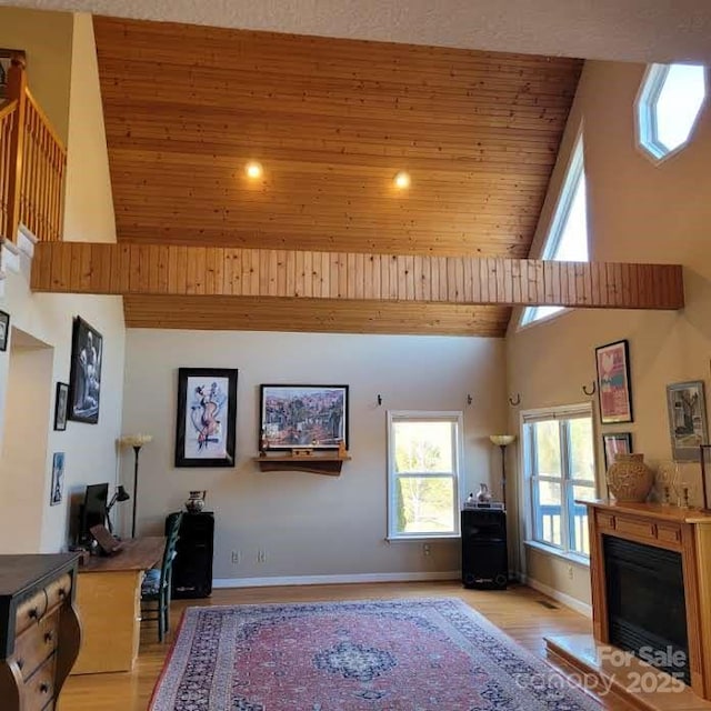 living room with high vaulted ceiling, baseboards, wood ceiling, and light wood finished floors