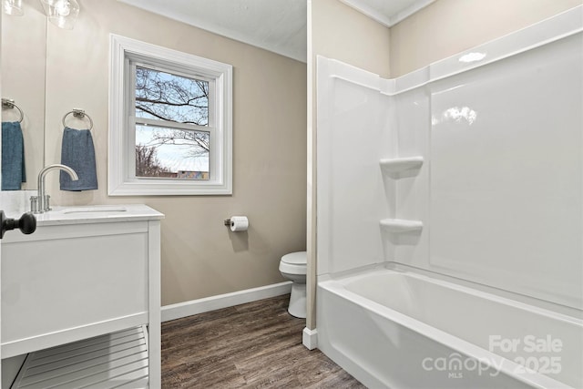 full bathroom featuring vanity, hardwood / wood-style flooring, shower / tub combination, and toilet