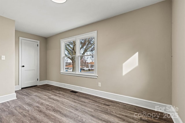 unfurnished room featuring hardwood / wood-style flooring