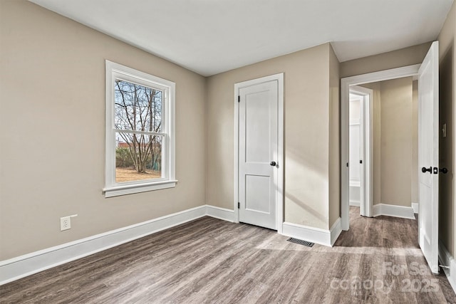 unfurnished bedroom with hardwood / wood-style flooring