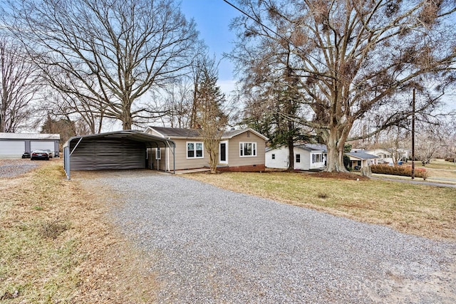 view of front of home with a front lawn and a carport