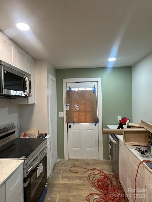 kitchen featuring white cabinetry and appliances with stainless steel finishes