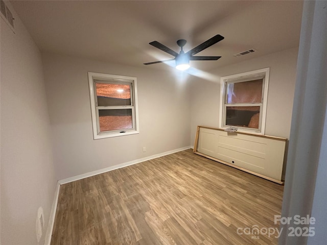 unfurnished bedroom with ceiling fan and light wood-type flooring