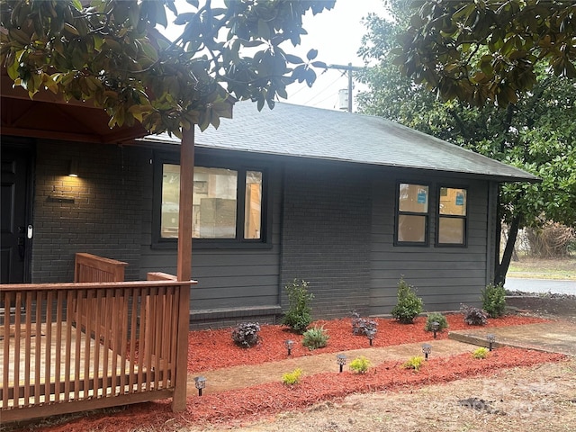 view of side of home with a wooden deck