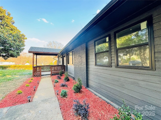 view of side of property featuring brick siding