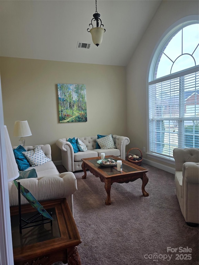 living room with lofted ceiling and carpet floors