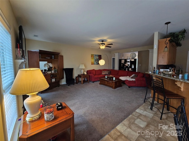 carpeted living room featuring ceiling fan