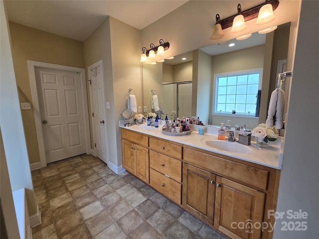 bathroom with a shower with door and vanity