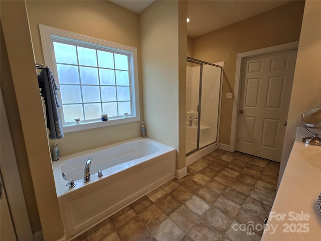 bathroom with shower with separate bathtub