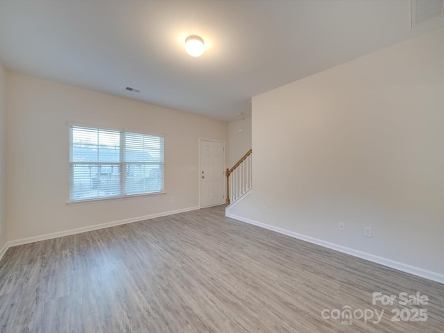 unfurnished room featuring light hardwood / wood-style floors