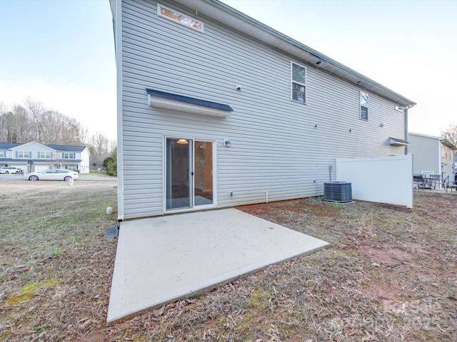 rear view of property with central AC unit and a patio area