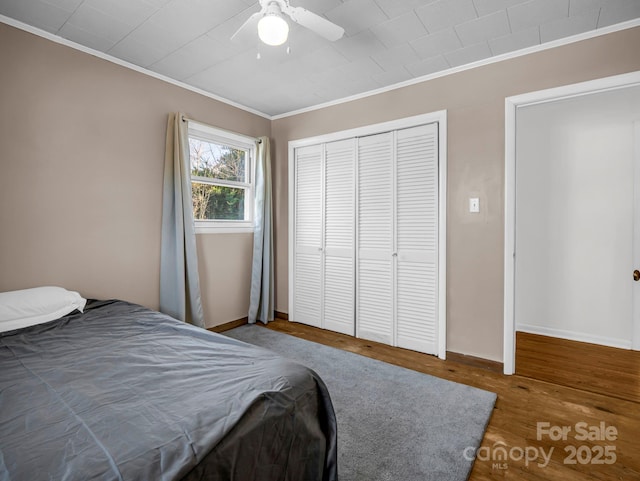 unfurnished bedroom featuring ornamental molding, hardwood / wood-style floors, and a closet