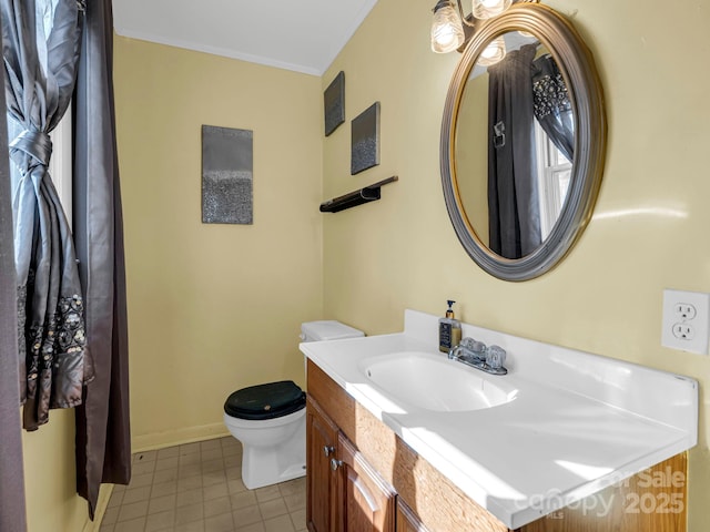 bathroom featuring ornamental molding, vanity, toilet, and tile patterned floors