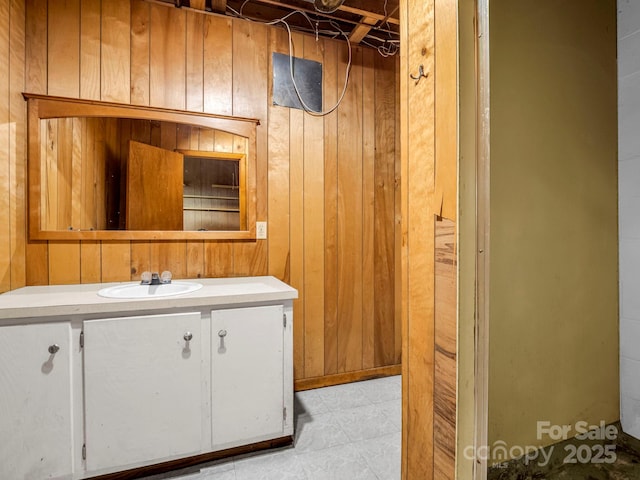 bathroom featuring vanity and wooden walls