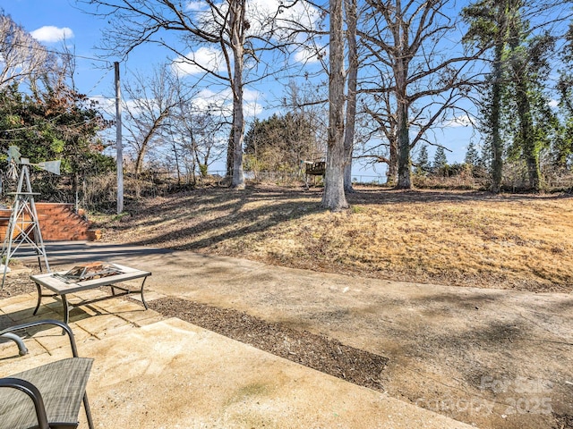 view of yard with a patio area and an outdoor fire pit