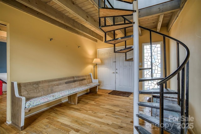 entryway featuring light hardwood / wood-style flooring, beamed ceiling, and wooden ceiling