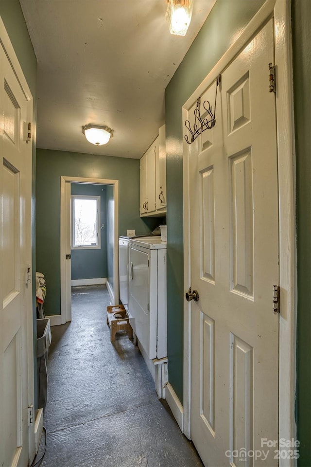 laundry room featuring cabinets and washer and clothes dryer