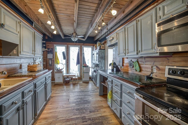 kitchen with hardwood / wood-style flooring, gray cabinetry, and stainless steel appliances