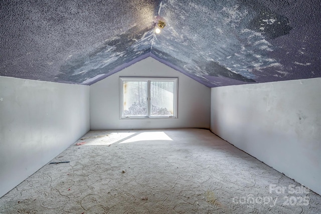 bonus room with vaulted ceiling, light carpet, and a textured ceiling