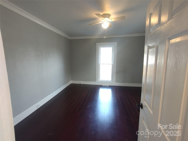 empty room with crown molding, dark hardwood / wood-style floors, and ceiling fan