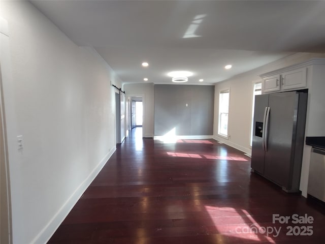 interior space featuring a barn door and dark hardwood / wood-style flooring