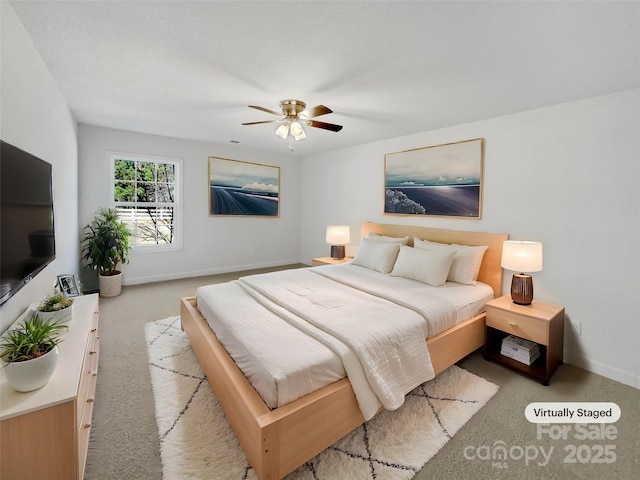 bedroom featuring light colored carpet and ceiling fan