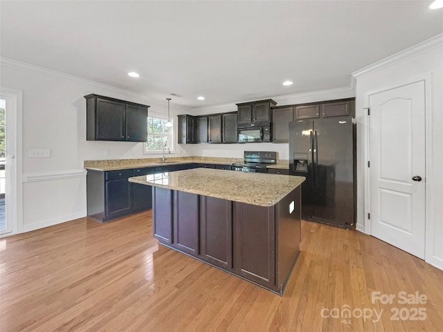 kitchen with crown molding, sink, pendant lighting, and black appliances