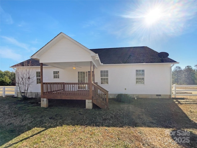 back of property featuring a wooden deck, a yard, and ceiling fan