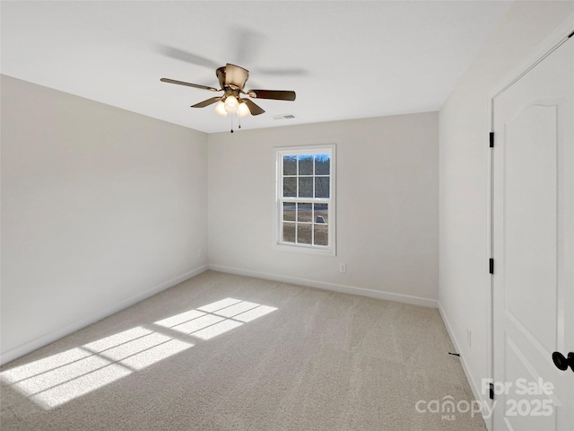 spare room with light carpet and ceiling fan