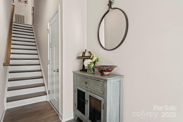 stairway with hardwood / wood-style floors