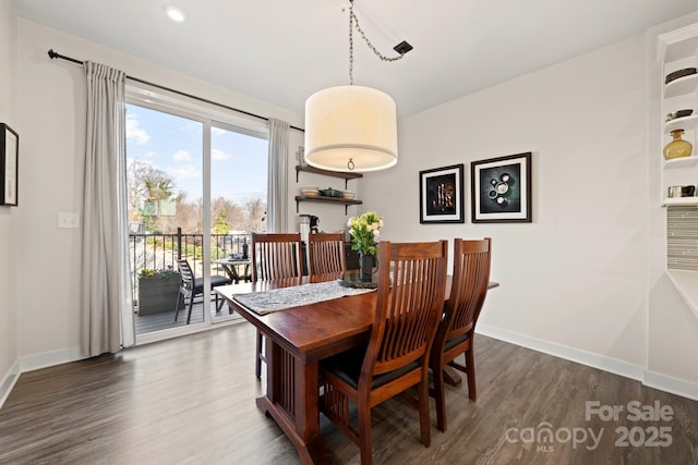 dining room with dark hardwood / wood-style flooring