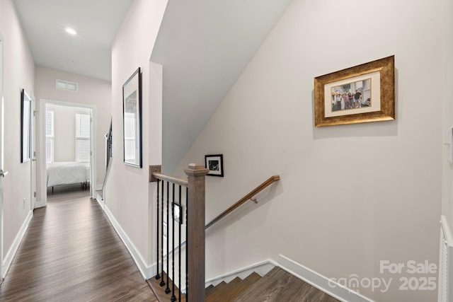 corridor with dark hardwood / wood-style flooring