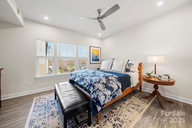 bedroom with dark hardwood / wood-style flooring and ceiling fan