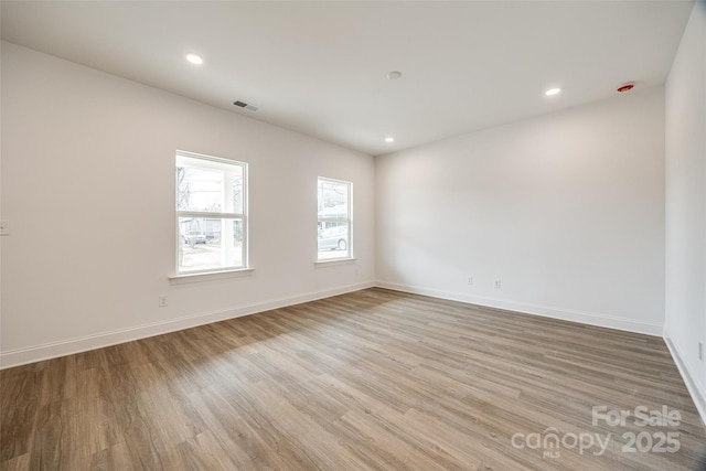 empty room with light hardwood / wood-style floors