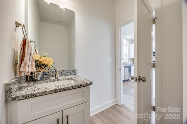 bathroom featuring vanity and hardwood / wood-style floors