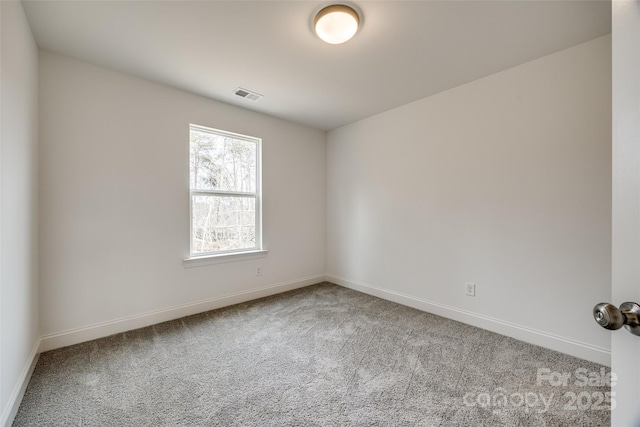 spare room featuring light colored carpet