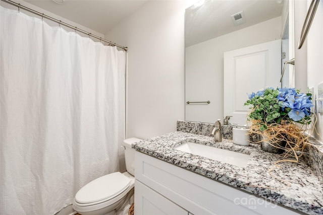 bathroom with vanity and toilet