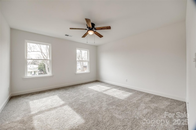 carpeted spare room with ceiling fan