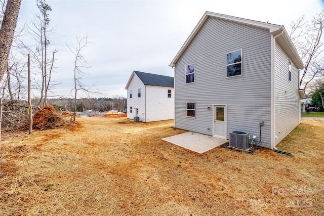 back of house with central AC unit and a patio