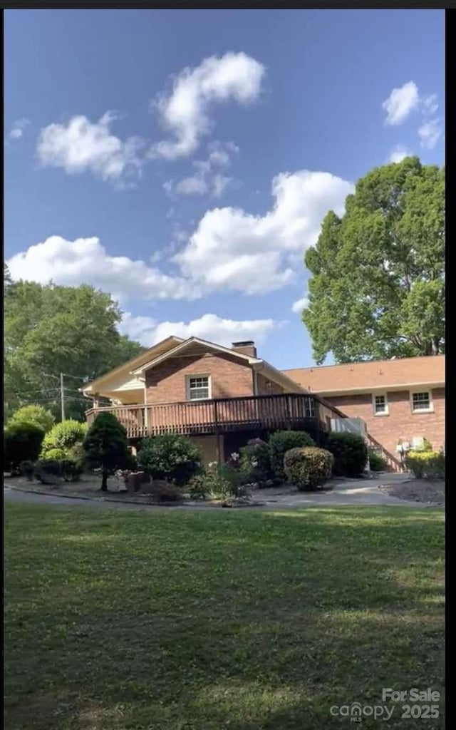 view of property exterior featuring a yard and a deck