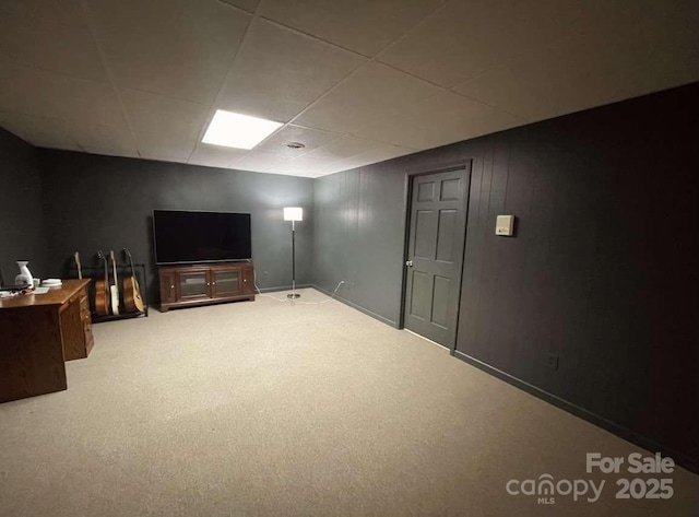 basement with carpet flooring and a drop ceiling