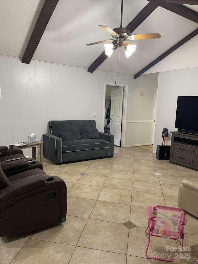 living room with light tile patterned flooring, ceiling fan, and beam ceiling