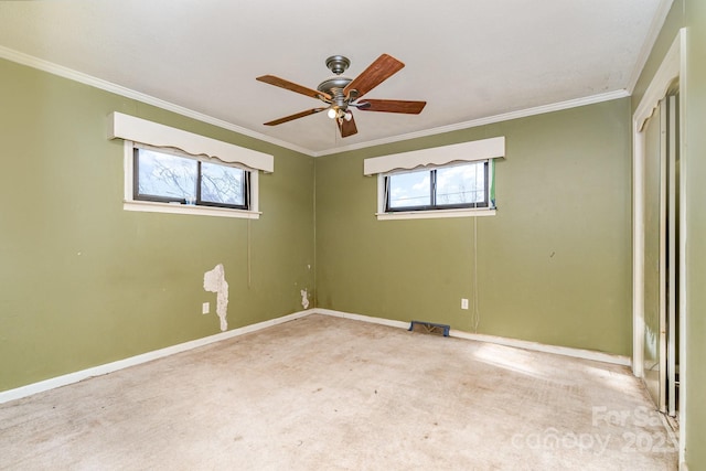 unfurnished bedroom with baseboards, multiple windows, carpet, and ornamental molding