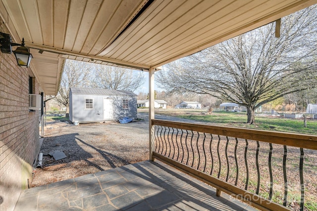 deck featuring a storage shed and an outdoor structure