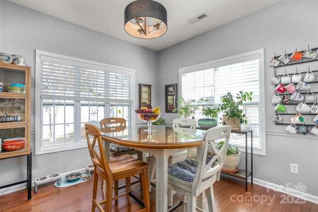 dining area with hardwood / wood-style flooring and plenty of natural light