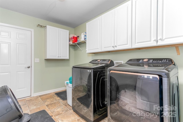 laundry room featuring cabinets and washer and clothes dryer