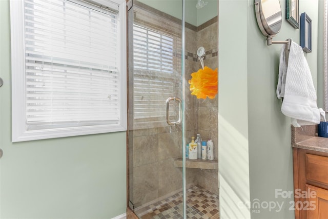 bathroom with vanity and a shower with shower door