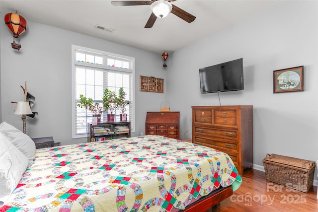 bedroom with hardwood / wood-style flooring and ceiling fan