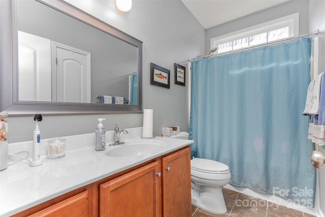 bathroom with tile patterned floors, vanity, and toilet