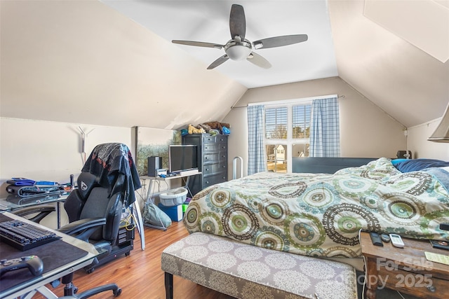 bedroom with lofted ceiling, hardwood / wood-style flooring, and ceiling fan